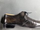 a pair of shoes that are on display in a glass case