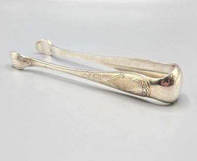 pair of silver spoons with garnets on them on a white surface