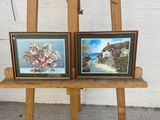 two paintings of flowers on a easel next to each other