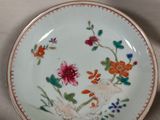 a plate with flowers on it sitting on a table