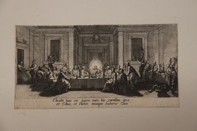 an old picture of a group of people sitting around a table