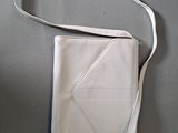 a white purse with a white strap on a table