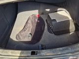 a bag in the trunk of a car with a hat in it