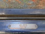 a close up of a blue suitcase with a painting on it