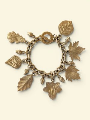 an image of a gold bracelet with charms and leaves