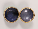 pair of blue and gold vases sitting on a white surface