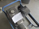 a blue cart with a pump and a sign on it