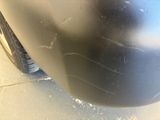 a close up of a car ' s bumper with scratches on it