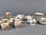 a lot of cups and saucers on the table