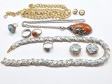 many different types of jewelry on a white surface