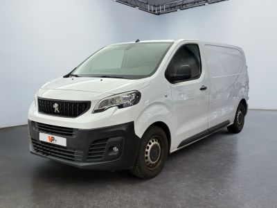 the small white van is parked in a large room