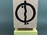 an image of a stone block with a black and white symbol on it