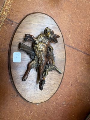 a bronze statue of a man on a horse on a table