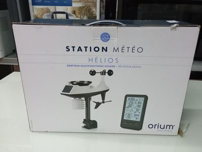 boxed box of a digital weather station sitting on top of a table