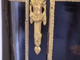 a black cabinet with gold trim and a door handle