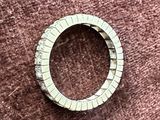 a picture of a ring on a brown surface
