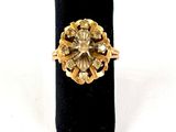 an image of a gold and diamond ring on a black ring holder