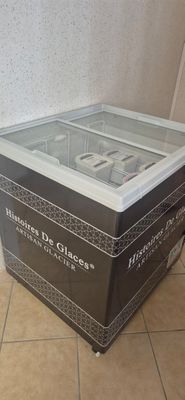 a glass display case with a remote on top of it