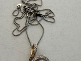 silver and black pearl pendant on a silver chain with a name tag