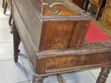 a wooden piano sitting on a tile floor in a room
