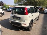 a small white car parked on the side of the road