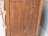 a wooden dresser with drawers and a mirror on the wall