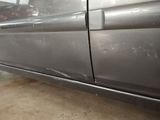 a picture of a car that has been painted silver in a garage