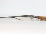 a rifle with a wooden barrel and a metal handle on a white background
