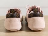louis vuittou pink and brown shoes on a wooden table