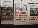 several posters on a wall in a room with black and white photos