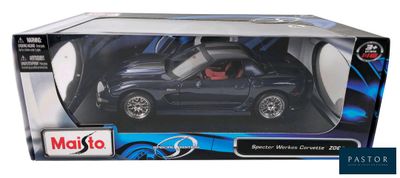 black toy car with red interior in a box on a white background