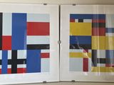 two framed pictures of different colors and shapes on the wall