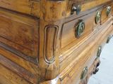 a large wooden chest of drawers with many knobs on it