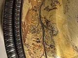 a gold plate with a picture of a woman on it