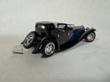 a black model of a car on a white surface