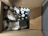 a cardboard box filled with assorted bottles and other items