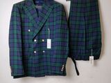 a green and blue plaid suit hanging on a wall next to a hanger