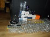 a lot of empty water glasses and a cell phone on the floor