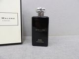 an image of a bottle of perfume next to a picture frame