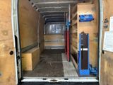 the back of a van with the door open and shelves in the back