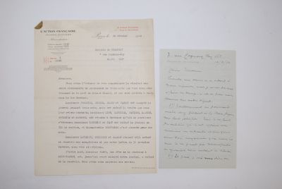 an old letter and a piece of paper on a table