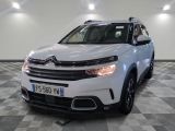 the white citrole suv is parked in a large room