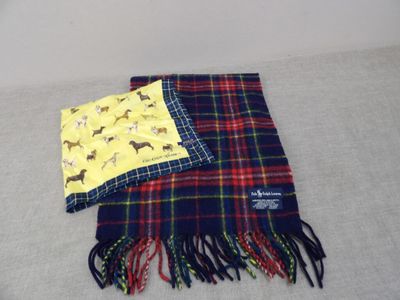 two scarves that are laying on a bed