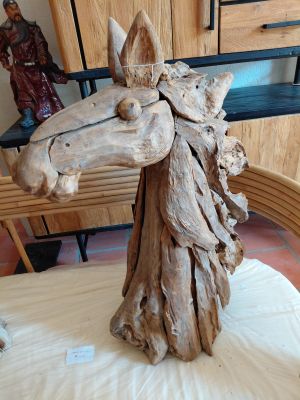 a wooden sculpture of a horse made of wood on a table