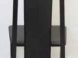 a black chair with a black seat on a white floor