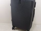 a piece of luggage sitting on the floor next to a tag