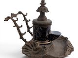 a black and gold teapot sitting on top of a table