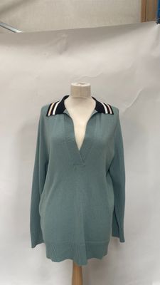 sweater on a mannequin stand with a white background