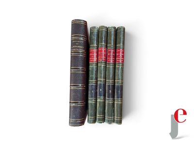 three old books sitting on top of each other on a white surface