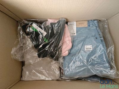 two pairs of pants in a box with plastic bags